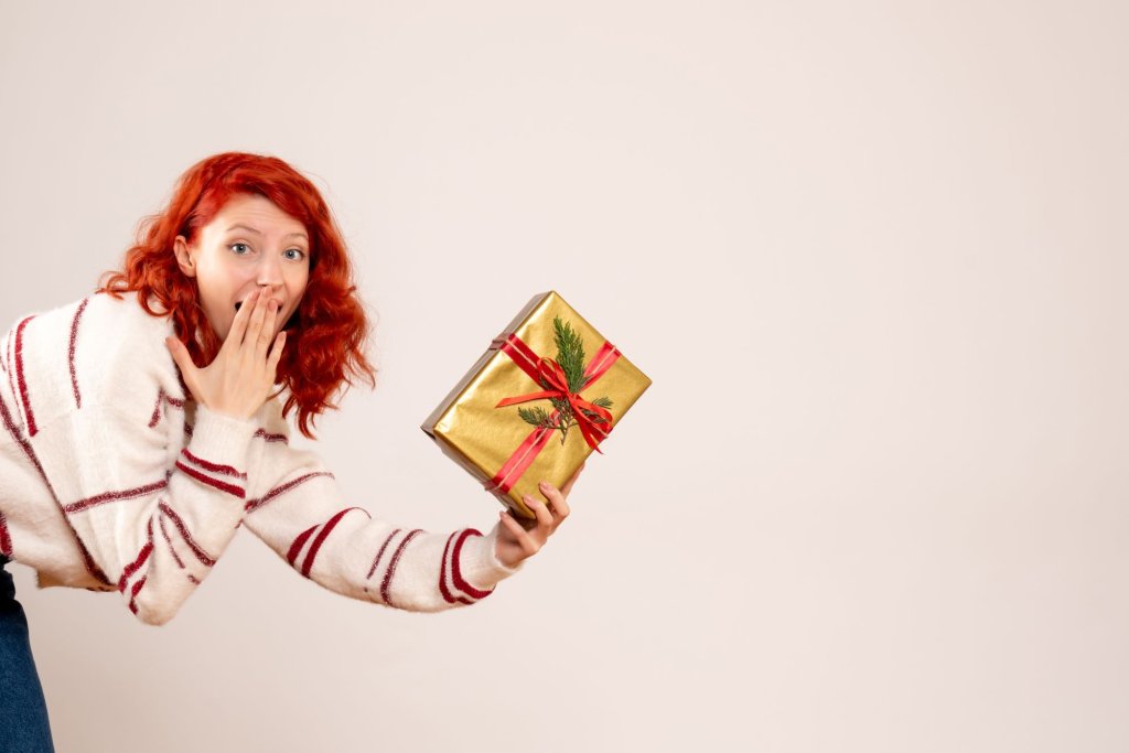 front-view-young-woman-with-christmas-present-white-wall.jpg