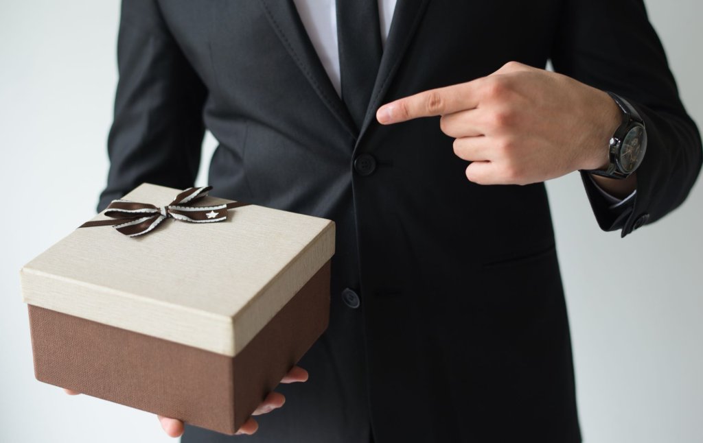 unrecognizable-businessman-holding-brown-gift-box.jpg