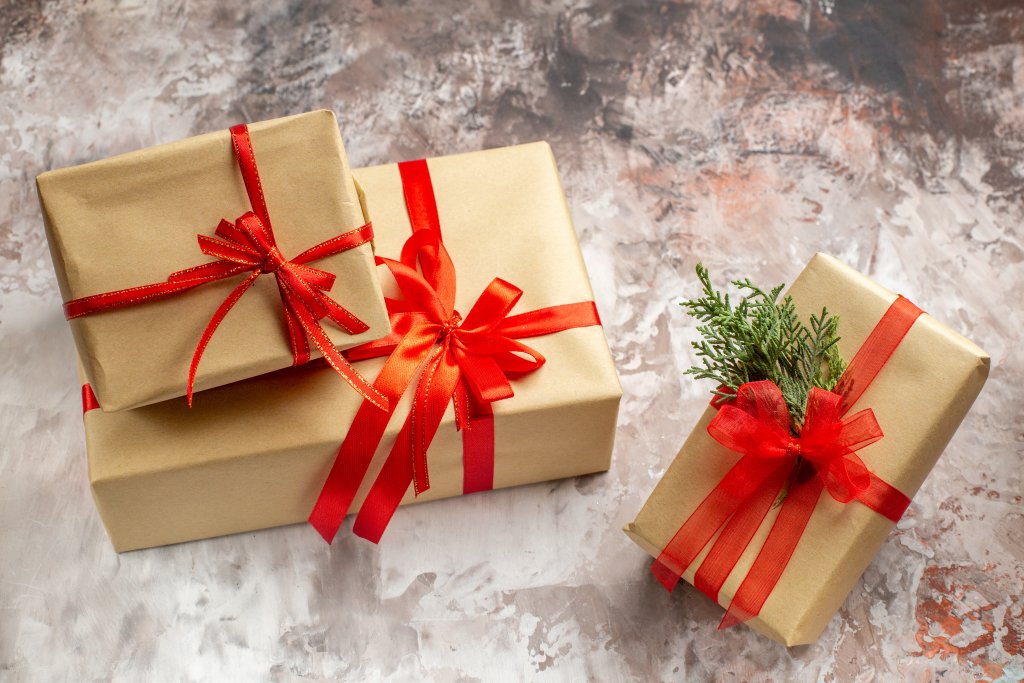 front-view-cute-christmas-presents-tied-with-red-bows-on-a-light-background.jpg