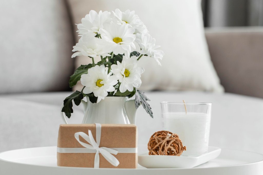 bouquet-white-flowers-vase-with-wrapped-gift.jpg