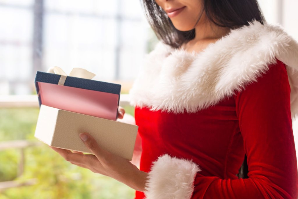 smiling-xmas-girl-unwrapping-blue-gift-box.jpg