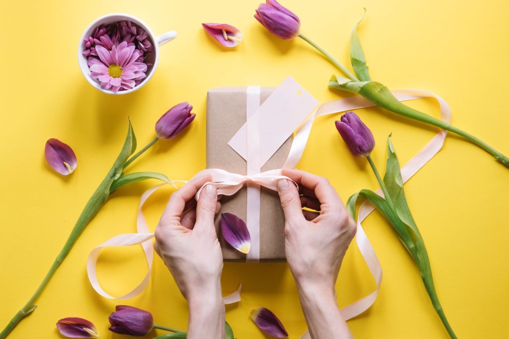 mothers-day-composition-with-hands-preparing-gift-box.jpg