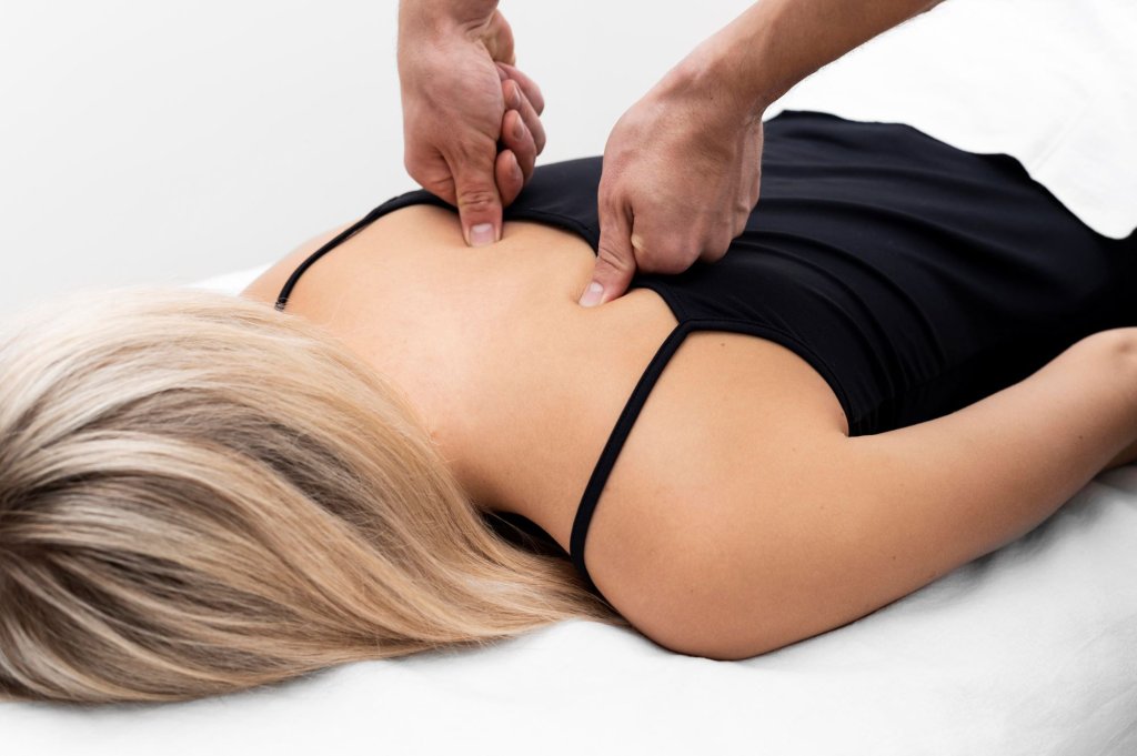 physiotherapist-performing-back-massage-female-patient.jpg