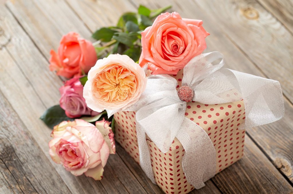 beautifully-wrapped-gift-bouquet-roses-blurred-wooden-table.jpg